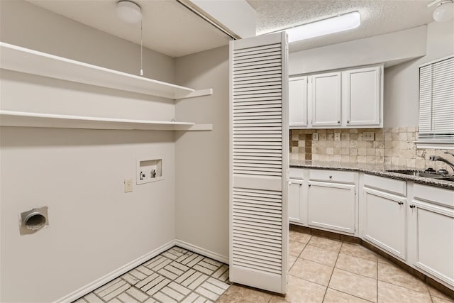 laundry room featuring washer hookup, hookup for an electric dryer, laundry area, a sink, and baseboards