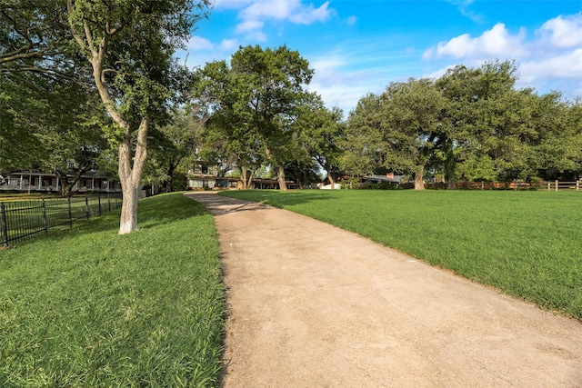 view of home's community featuring a yard and fence
