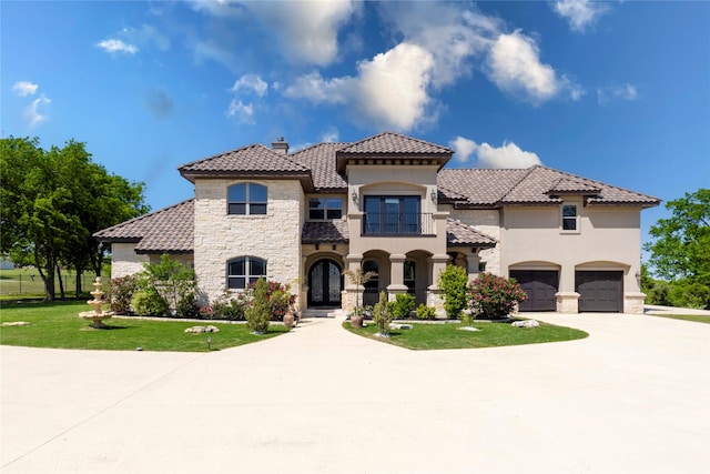 mediterranean / spanish home featuring a chimney, curved driveway, a tile roof, french doors, and stone siding