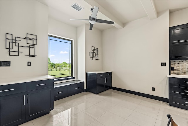 interior space featuring light countertops, visible vents, ceiling fan, and dark cabinets