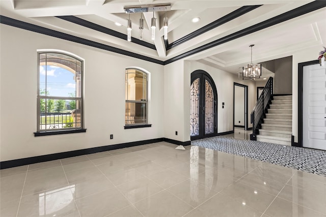 tiled entrance foyer featuring french doors, a notable chandelier, stairs, crown molding, and a raised ceiling