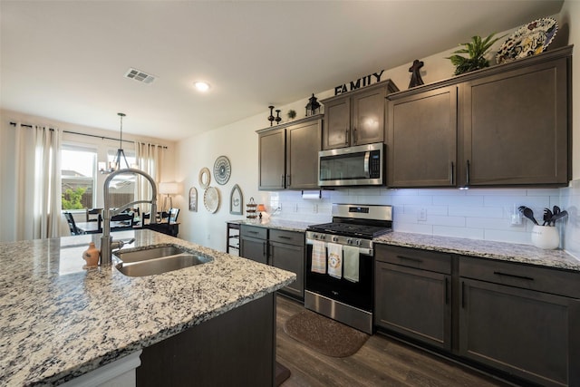 503 Saddle Club Way, Princeton, TX 75407 - kitchen with tasteful backsplash, dark wood-style flooring, visible vents, and stainless steel appliances