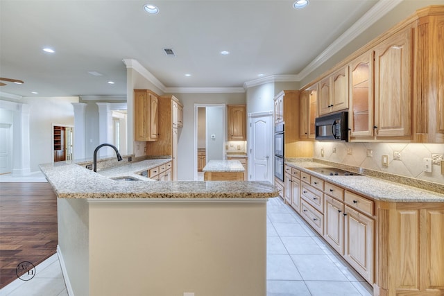 kitchen with a sink, visible vents, recessed lighting, light stone counters, and black appliances