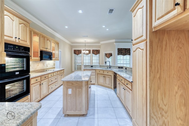 kitchen featuring visible vents, light brown cabinetry, a sink, and black appliances