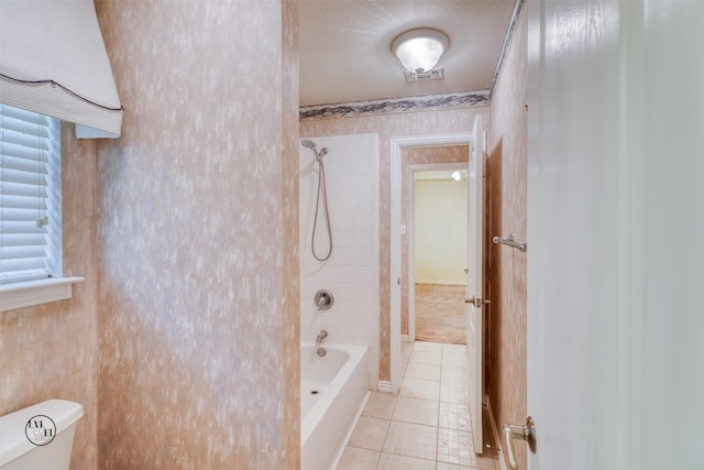 bathroom featuring toilet, bathtub / shower combination, and tile patterned floors