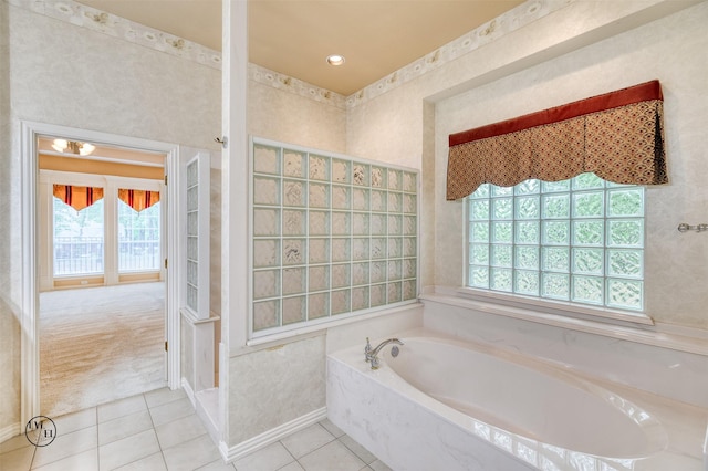 full bath with a garden tub, tile patterned flooring, and a walk in shower