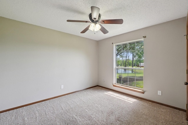 empty room featuring baseboards, a ceiling fan, carpet flooring, and a textured ceiling