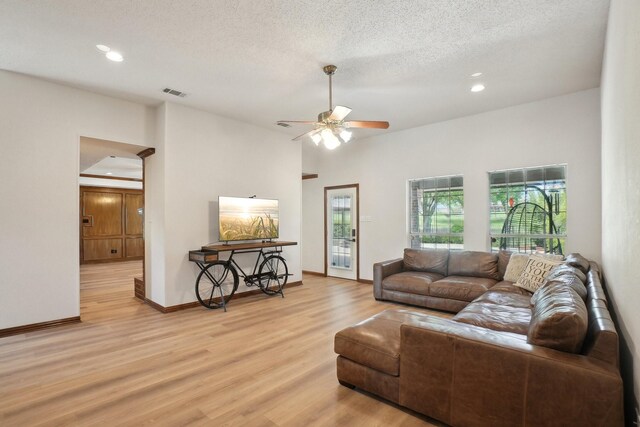 living area with recessed lighting, visible vents, a ceiling fan, light wood-style flooring, and a textured ceiling