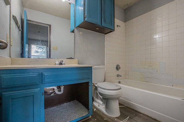 full bathroom featuring toilet, vanity, wood finished floors, and bathing tub / shower combination