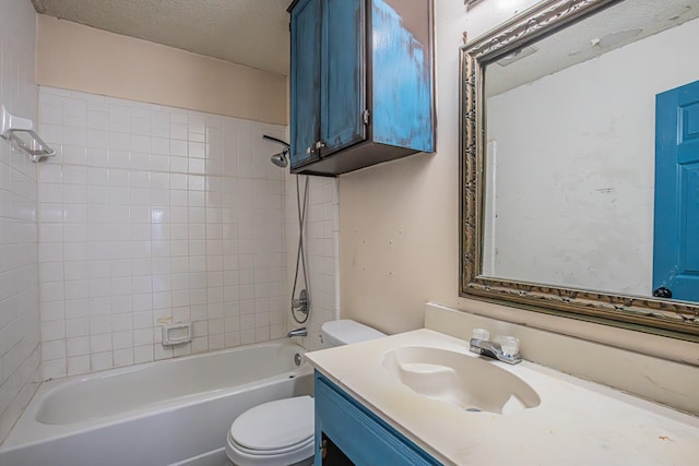 bathroom with tub / shower combination, a textured ceiling, toilet, and vanity