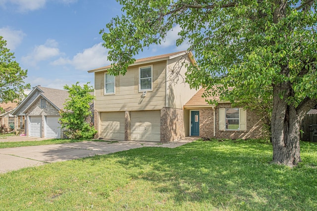 view of front of property featuring brick siding, an attached garage, a front yard, and concrete driveway