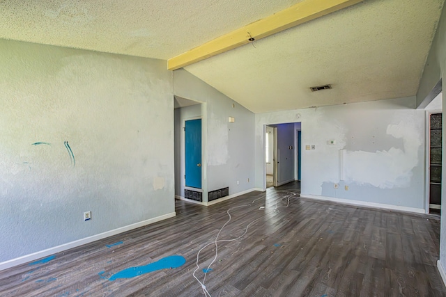 empty room with wood finished floors, visible vents, vaulted ceiling with beams, and baseboards
