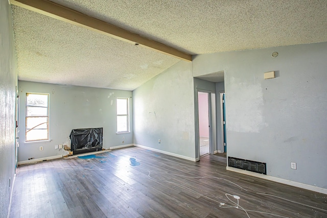 unfurnished living room with wood finished floors, visible vents, vaulted ceiling with beams, and baseboards