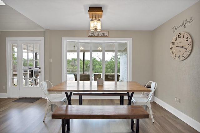 dining area with plenty of natural light, baseboards, and wood finished floors