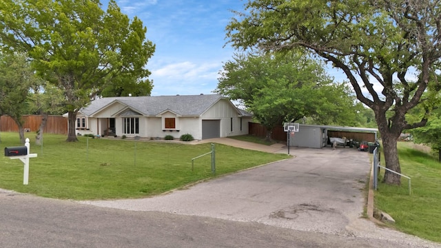 ranch-style home with fence, driveway, a front yard, and a garage