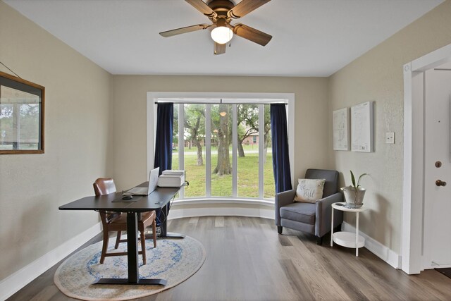 office with baseboards, a ceiling fan, and wood finished floors