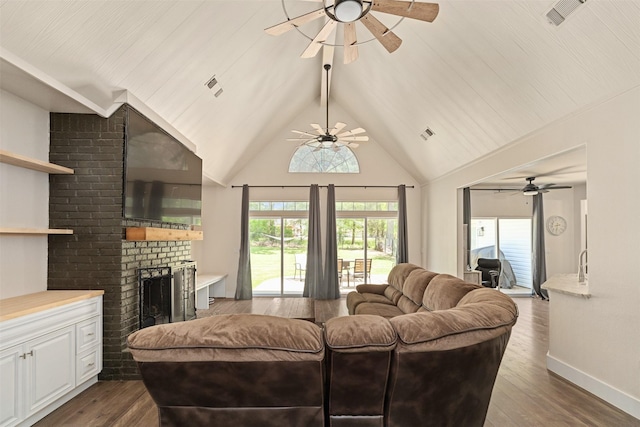 living area with a ceiling fan, visible vents, a fireplace, and dark wood-style flooring