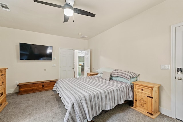 bedroom with light colored carpet, ceiling fan, baseboards, and visible vents