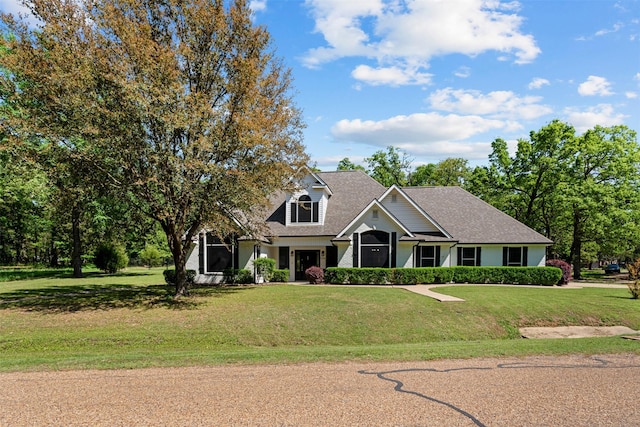 cape cod home with a front lawn and roof with shingles