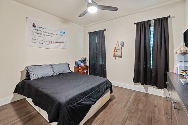 bedroom with wood finished floors, baseboards, and ceiling fan