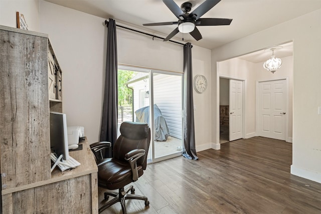 office featuring dark wood finished floors, baseboards, and ceiling fan with notable chandelier