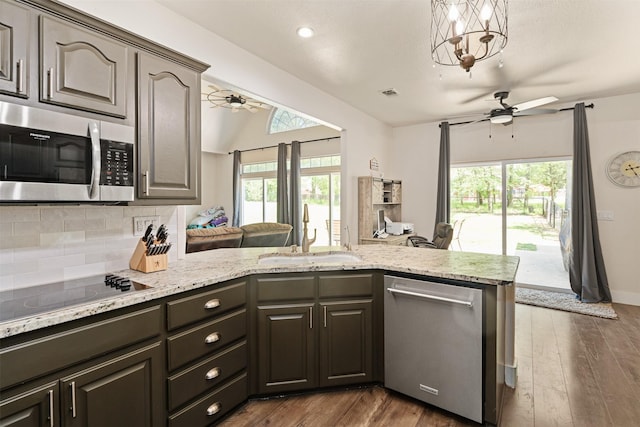 kitchen with tasteful backsplash, a ceiling fan, stainless steel appliances, and a sink