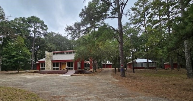 rustic home with driveway and a porch