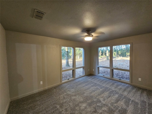 unfurnished room with ceiling fan, baseboards, carpet flooring, and visible vents