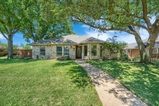 ranch-style home with brick siding and a front yard