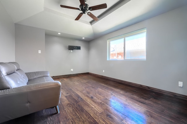 sitting room with a raised ceiling, a ceiling fan, baseboards, recessed lighting, and wood finished floors