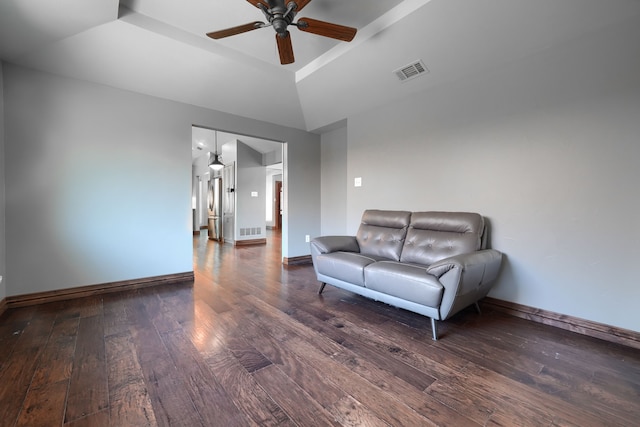 living area with ceiling fan, visible vents, baseboards, and hardwood / wood-style flooring
