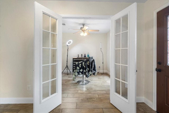doorway with baseboards, french doors, wood finished floors, and ceiling fan