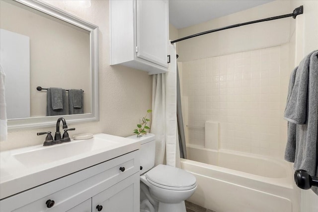 bathroom featuring shower / bath combo, toilet, a textured wall, and vanity