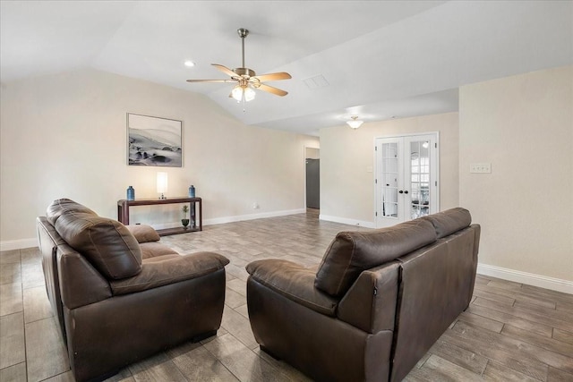 living area featuring vaulted ceiling, a ceiling fan, french doors, and baseboards