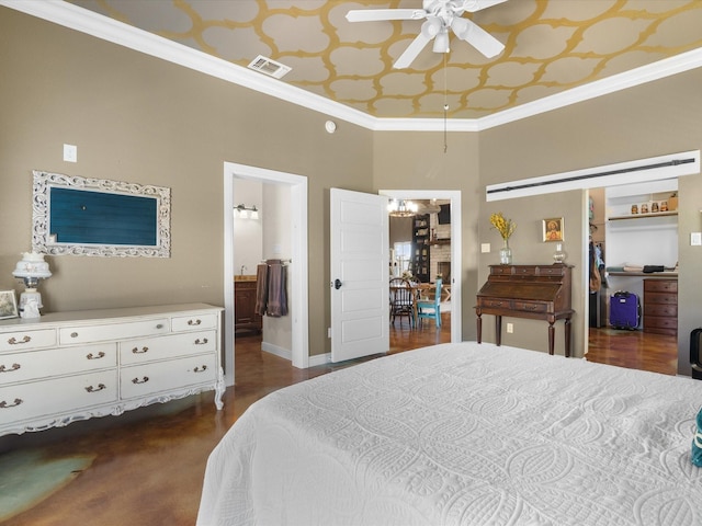 bedroom featuring baseboards, visible vents, a spacious closet, and crown molding