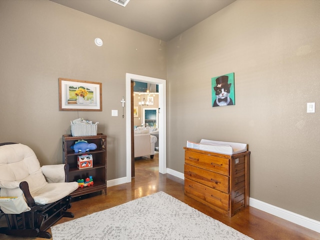 living area with concrete flooring and baseboards