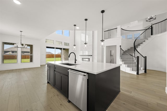 301 E Cheyenne Mountain Cor, Ovilla, TX 75154 - kitchen with a chandelier, dishwasher, a sink, light countertops, and a towering ceiling