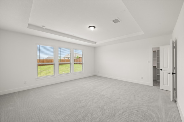 301 E Cheyenne Mountain Cor, Ovilla, TX 75154 - empty room featuring a tray ceiling, light colored carpet, and baseboards