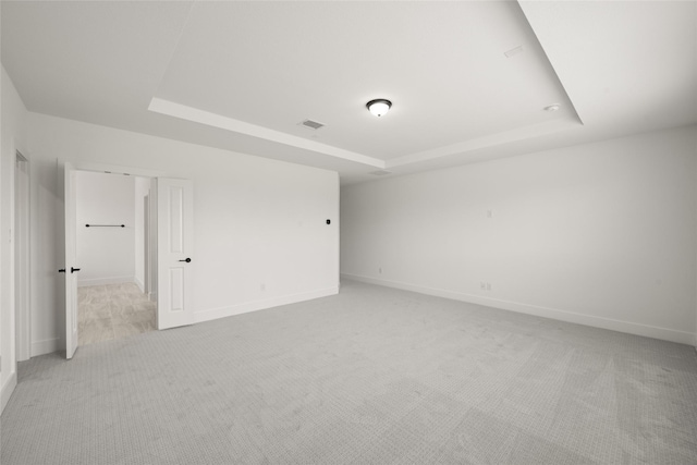 301 E Cheyenne Mountain Cor, Ovilla, TX 75154 - empty room featuring a tray ceiling, light colored carpet, and baseboards