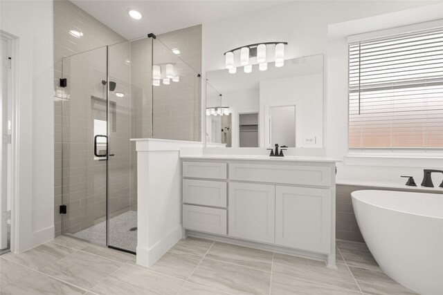 301 E Cheyenne Mountain Cor, Ovilla, TX 75154 - bathroom featuring a shower stall, vanity, a freestanding tub, plenty of natural light, and recessed lighting
