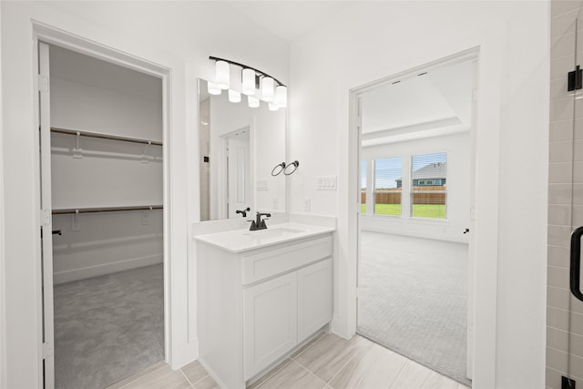 301 E Cheyenne Mountain Cor, Ovilla, TX 75154 - bathroom with a walk in closet, vanity, baseboards, and an enclosed shower