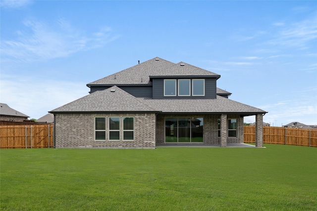 301 E Cheyenne Mountain Cor, Ovilla, TX 75154 - back of house with a shingled roof, brick siding, and a patio area