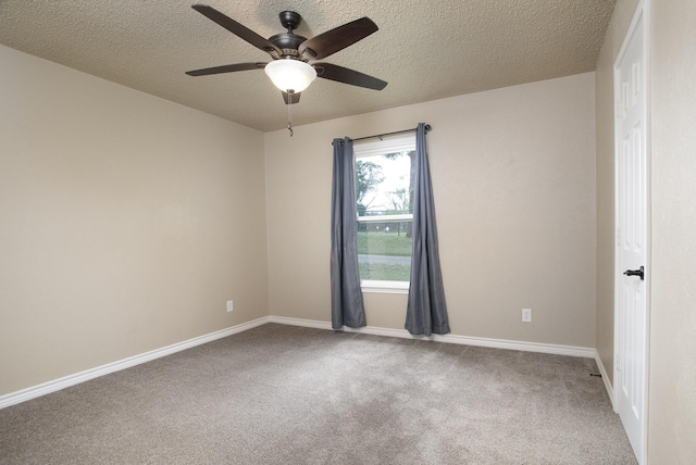empty room with carpet, a textured ceiling, a ceiling fan, and baseboards