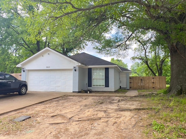 2631 Lillian St, Shreveport, LA 71103 - ranch-style house with an attached garage, fence, brick siding, and concrete driveway