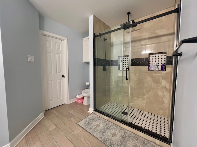 2631 Lillian St, Shreveport, LA 71103 - bathroom with a shower stall, baseboards, toilet, and wood finished floors