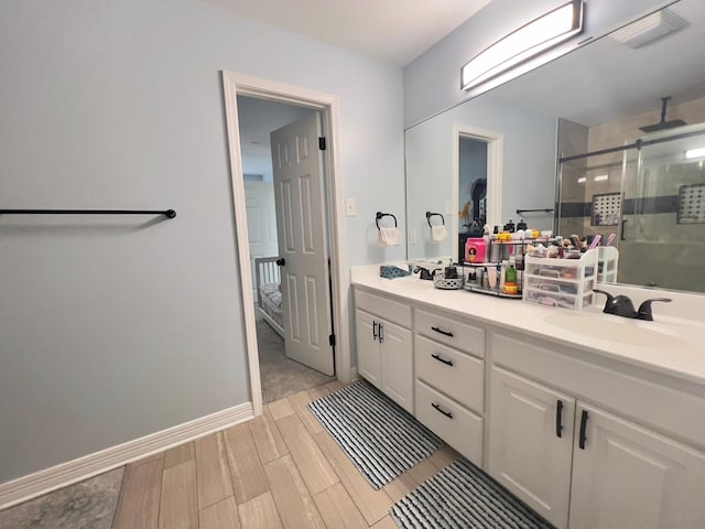 2631 Lillian St, Shreveport, LA 71103 - bathroom featuring double vanity, a shower stall, wood finish floors, and a sink