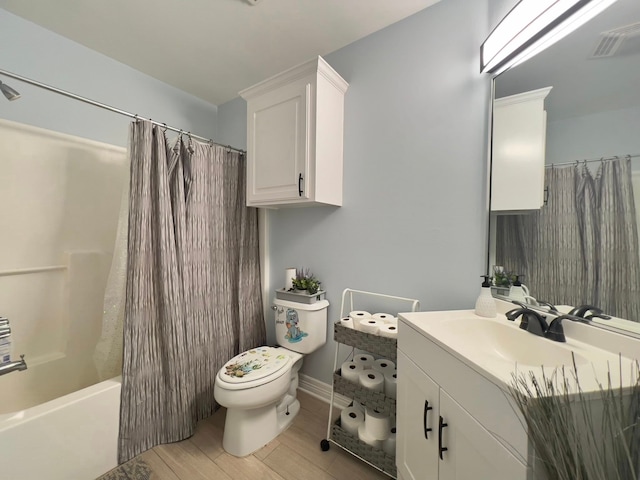 2631 Lillian St, Shreveport, LA 71103 - full bath with wood finished floors, vanity, shower / tub combo, toilet, and visible vents