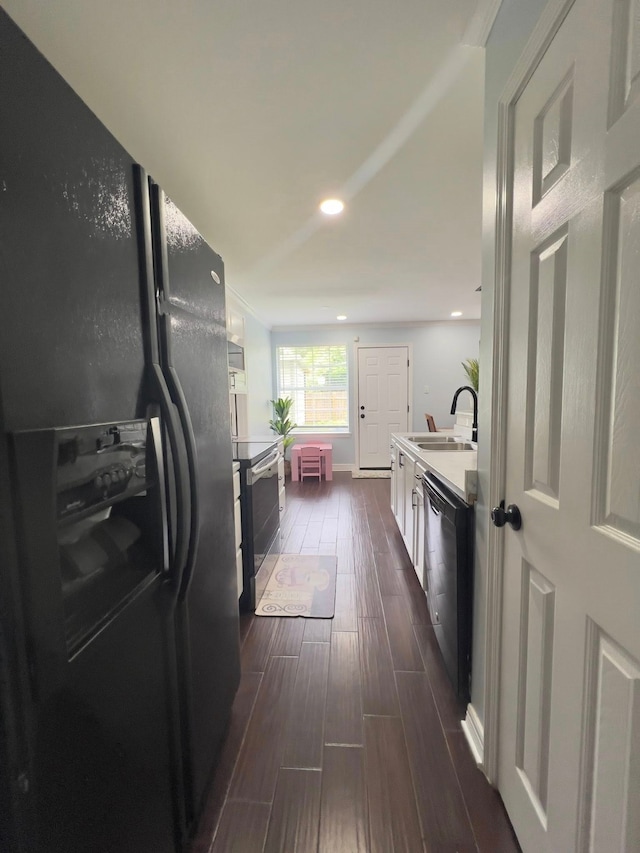 2631 Lillian St, Shreveport, LA 71103 - kitchen featuring recessed lighting, a sink, dark wood-type flooring, baseboards, and black appliances
