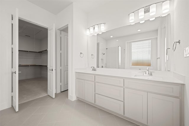 431 Broadmoor, Ovilla, TX 75154 - bathroom featuring a stall shower, a walk in closet, double vanity, tile patterned floors, and recessed lighting