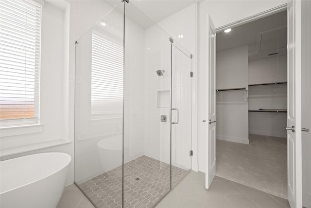431 Broadmoor, Ovilla, TX 75154 - bathroom featuring a shower stall, a freestanding bath, tile patterned floors, and a spacious closet
